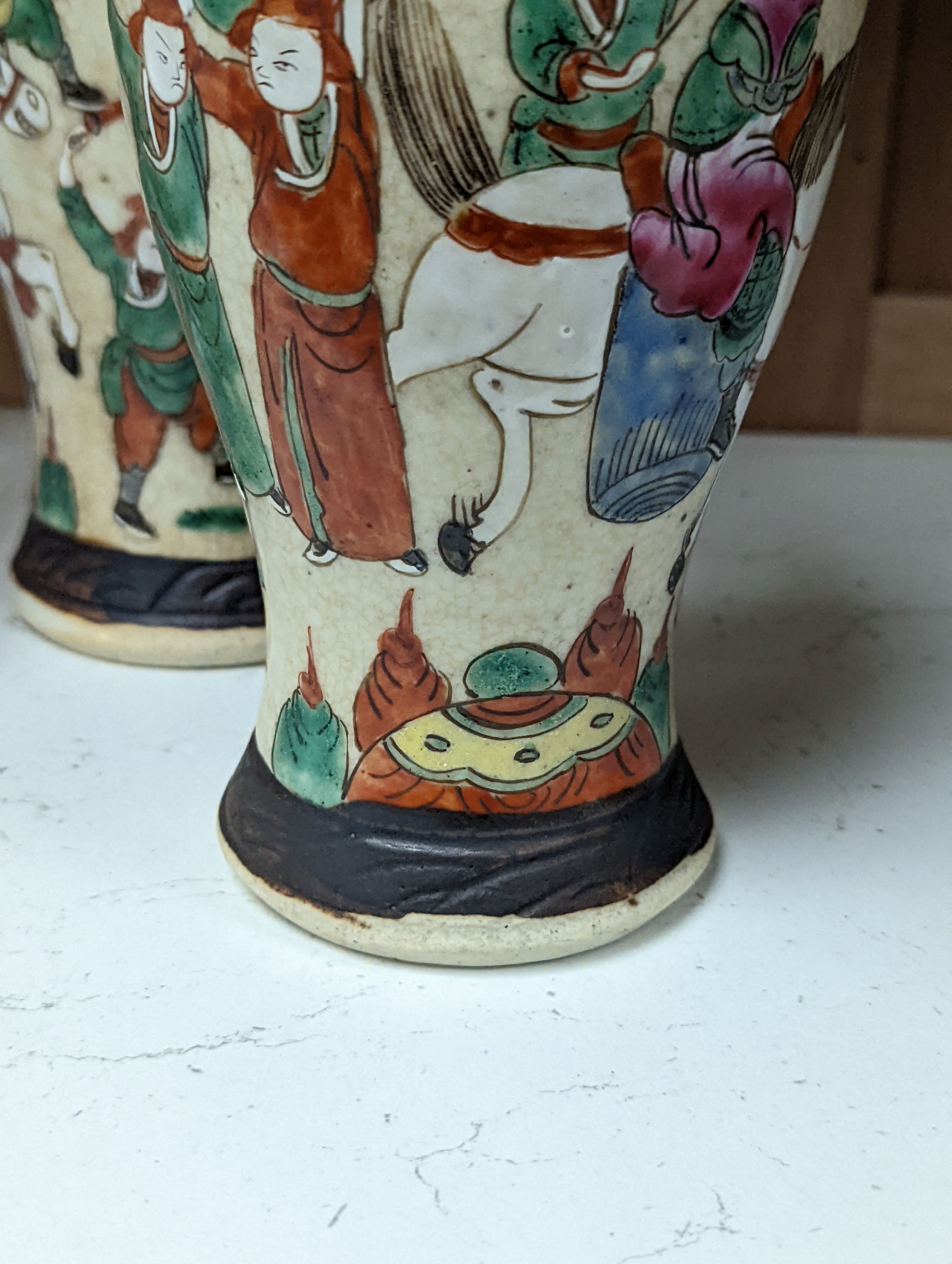 A pair of Chinese famille rose crackle glaze baluster jars and covers, 27cm.